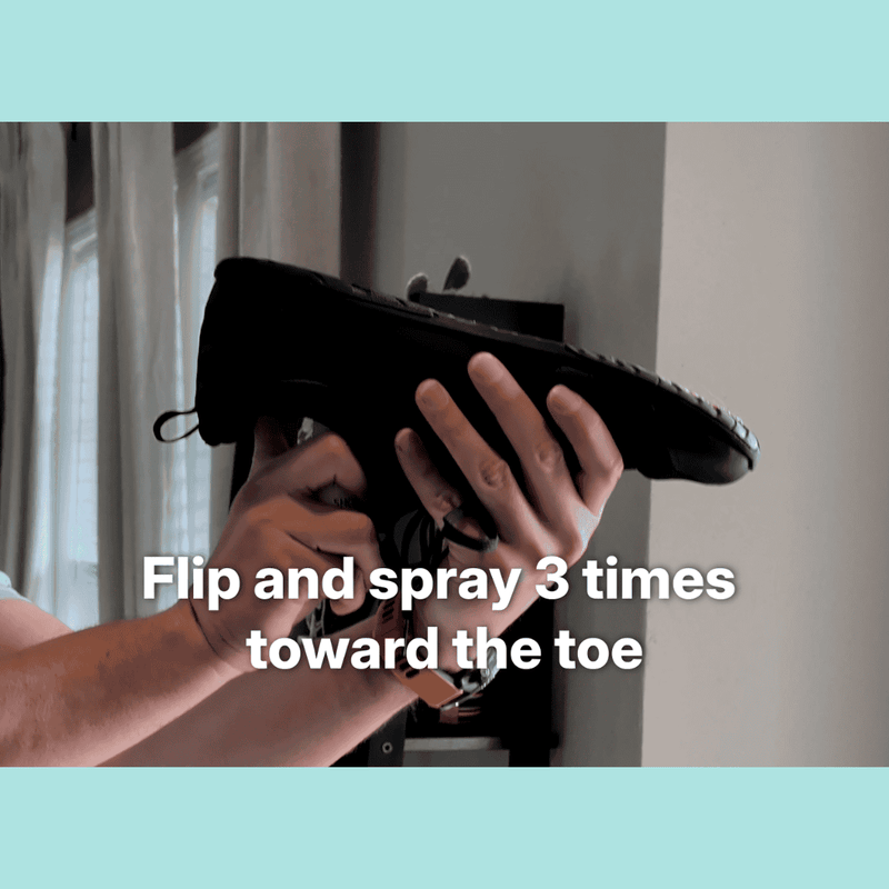 Spraying MyFootology shoe spray toward the toe box of a flipped shoe